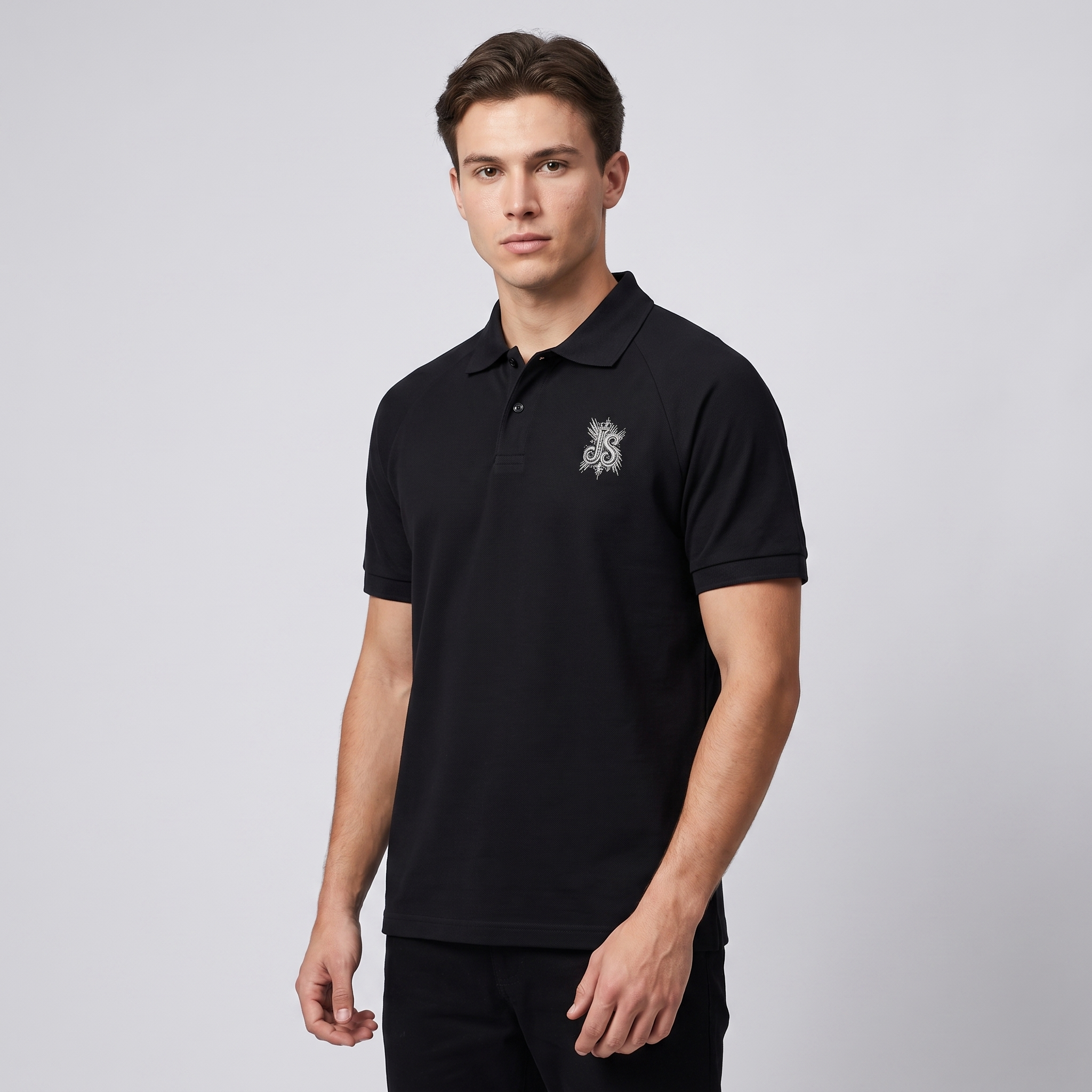 Model wearing the JUKE Unisex Regular Fit Polo Shirt in black, studio shot