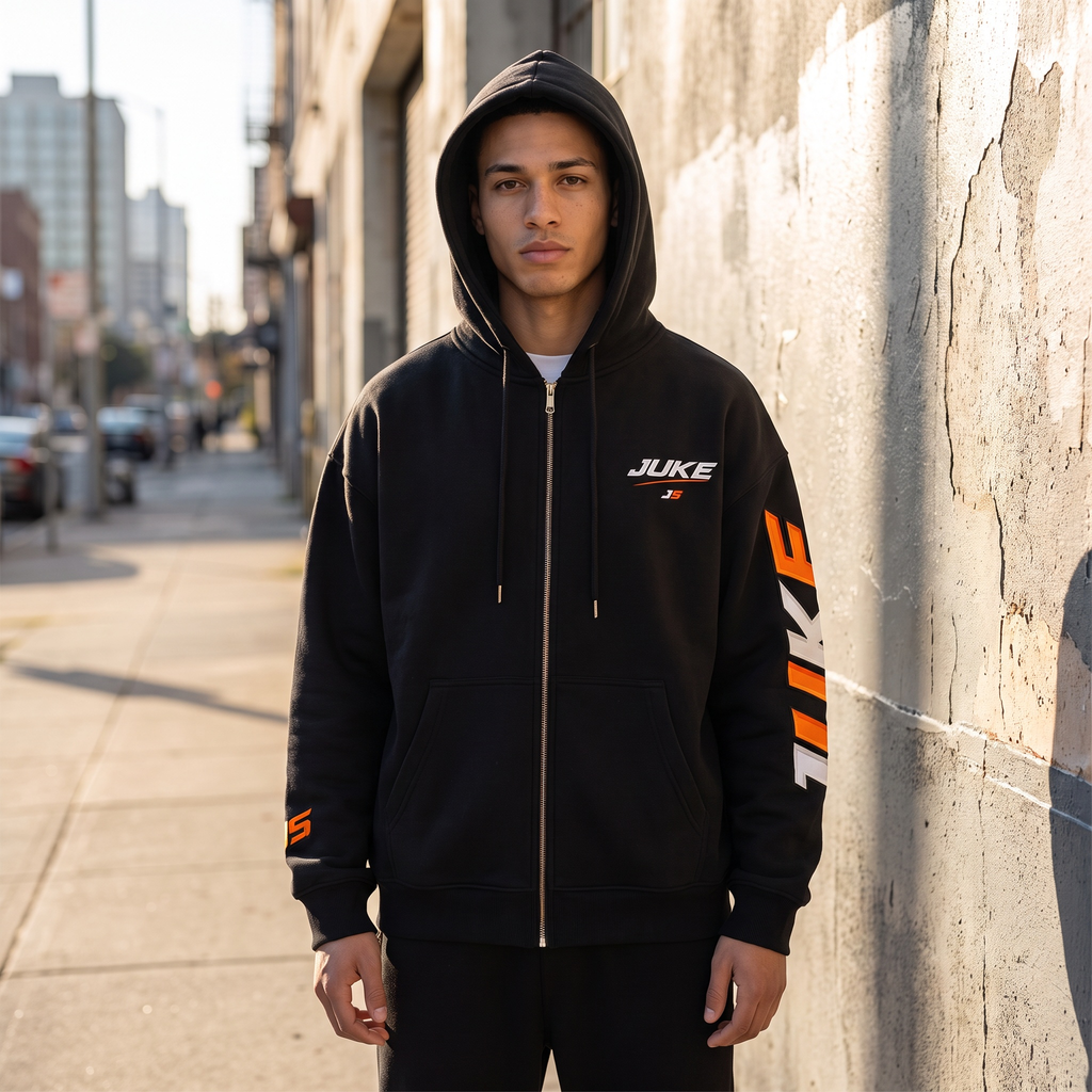 Model wearing the JUKE Essential Oversized Fleece Boxy Hoodie in black on a city street