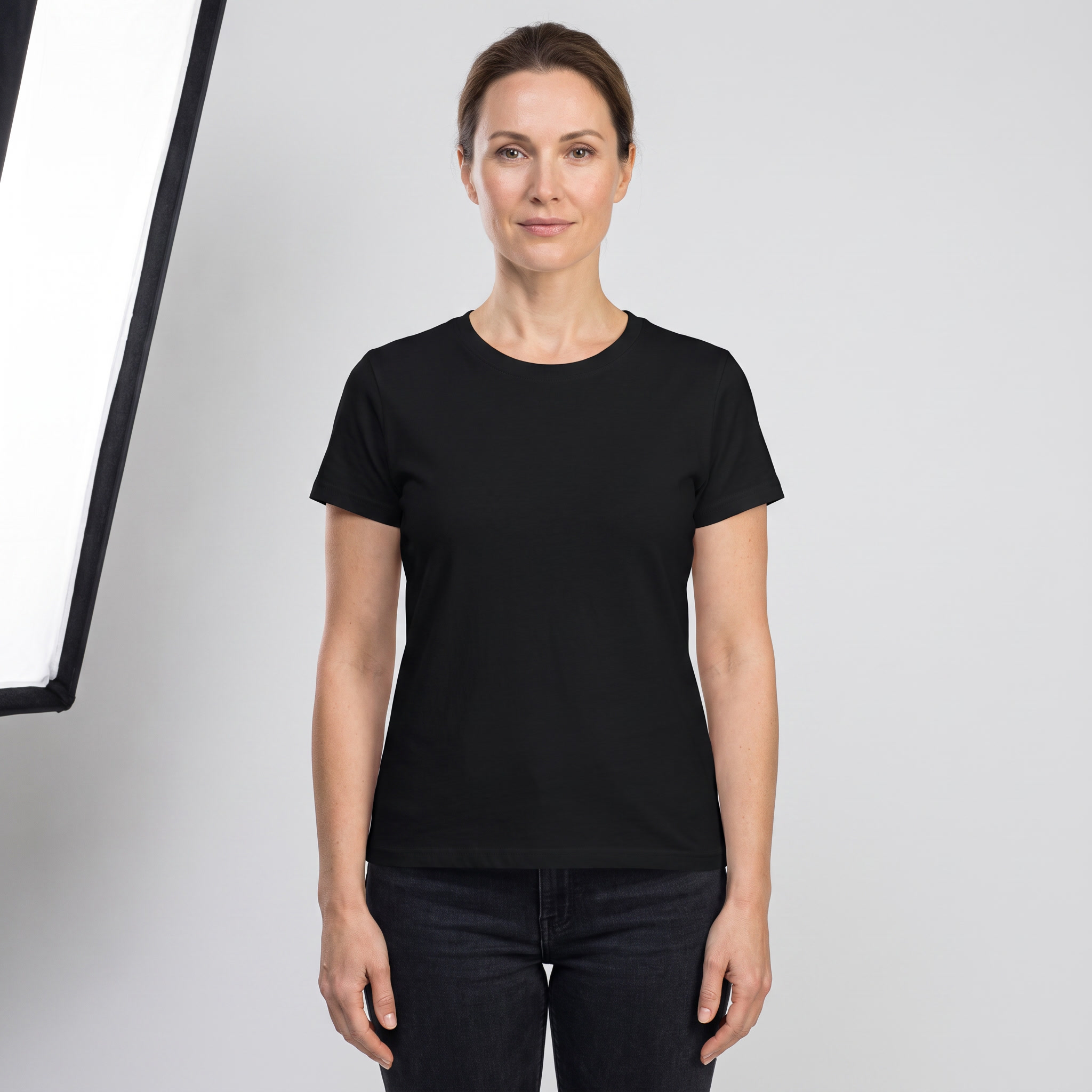 Model wearing the JUKE Women's Slim Fit Crewneck T-Shirt in black, studio shot