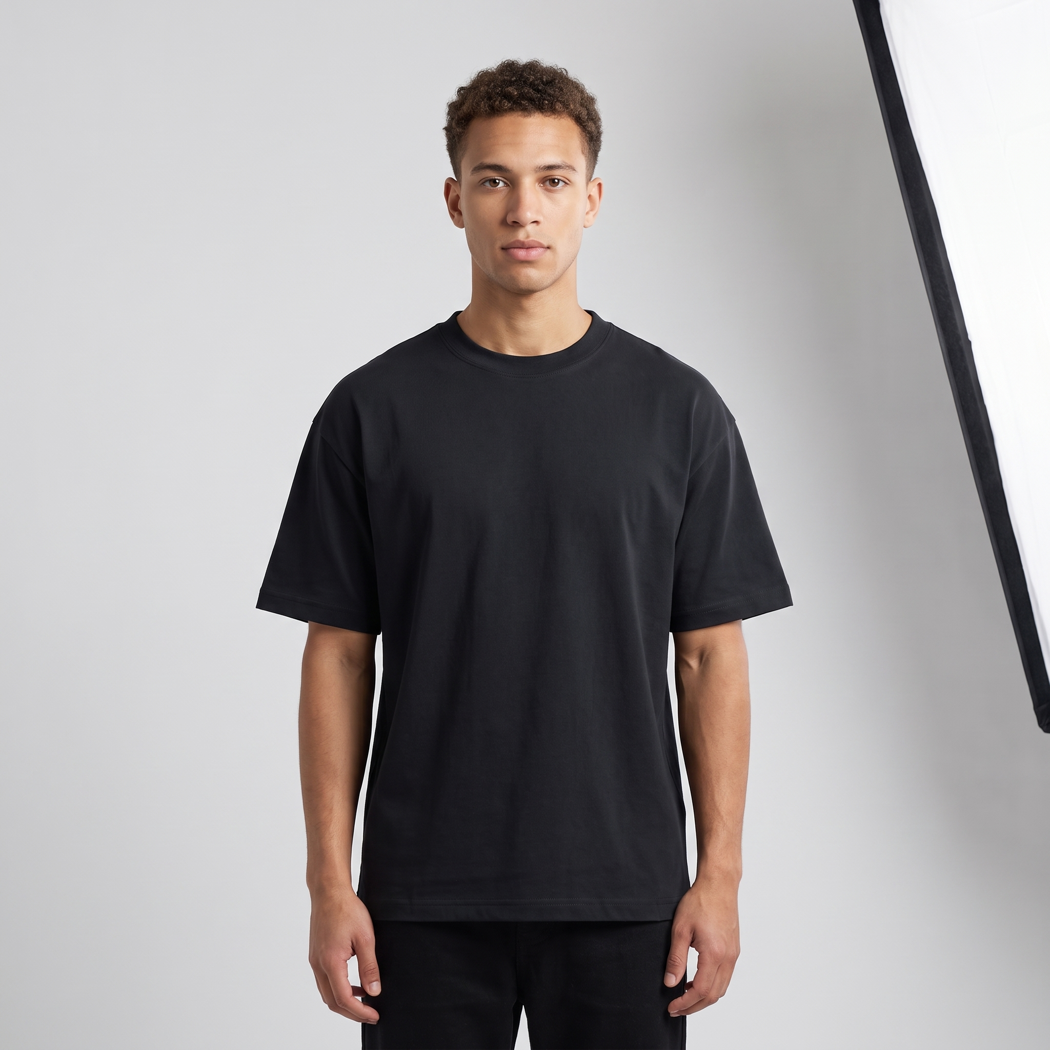 Model wearing the JUKE Unisex Drop Shoulder Cotton T-Shirt, studio shot
